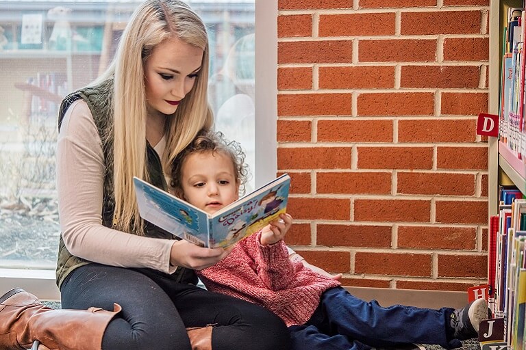 mother reading to daughter