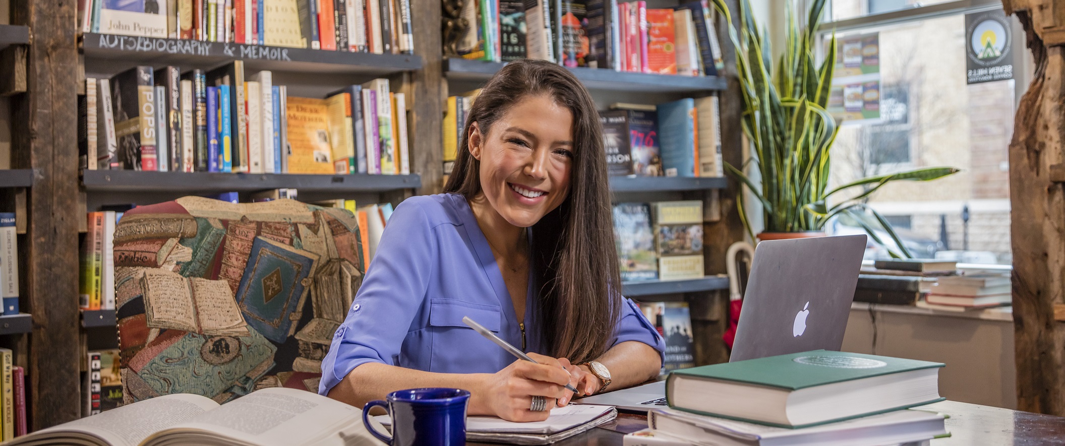 girl in book store studying with coffee and laptop